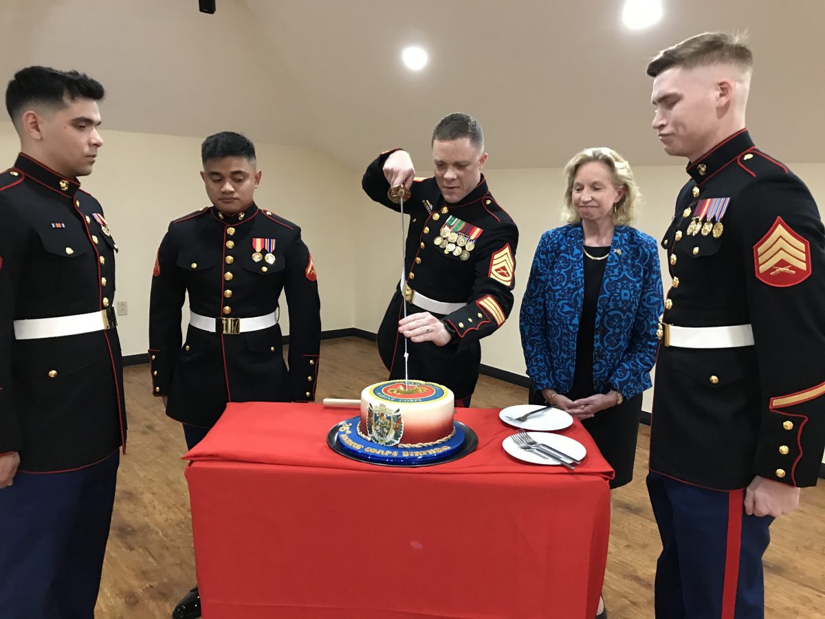 The cutting of the cake. US Ambassador Sarah-Ann Lynch is second from right.
