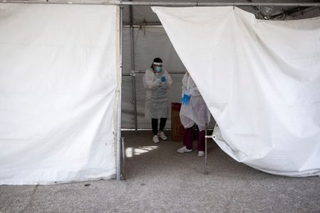 FILE PHOTO: Medical personnel are seen inside an admin tent after administering free Covid-19 tests at a state run drive-through testing site in the parking lot of the University of Texas El Paso campus amid the coronavirus disease (COVID-19) outbreak, in El Paso, Texas, U.S. November 23, 2020. REUTERS/Ivan Pierre Aguirre