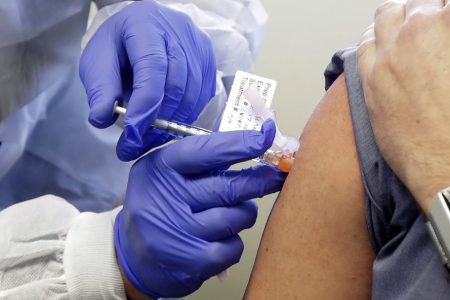 In this March 16, 2020, file photo, Neal Browning receives a shot in the first-stage safety study of a potential vaccine for COVID-19 at the Kaiser Permanente Washington Health Research Institute in Seattle. (AP Photo/Ted S. Warren, File)
