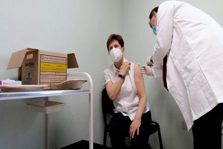 Hungarian head physician Adrienne Kertesz receives a vaccine after the first batch of the Pfizer-BioNTech vaccines against the new coronavirus bought by Hungary arrived at the Southern Pest Central Hospital in Budapest, Hungary (AP)