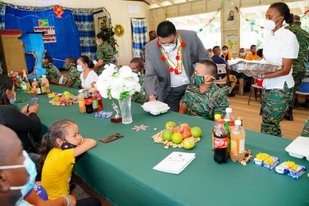 President Irfaan Ali serving lunch to soldiers at Kaikan on Friday (Office of the President photo) 