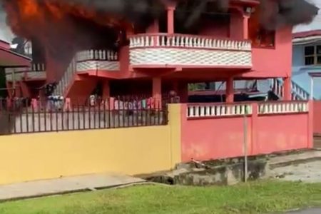 The house engulfed in flames  (Screenshot of Romena Ally’s video)