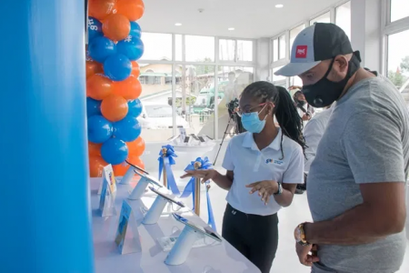 A GTT worker interacts with one of the first customers accessing services at the company’s new store at Grove, on the East Bank of Demerara. (DPI photo)  