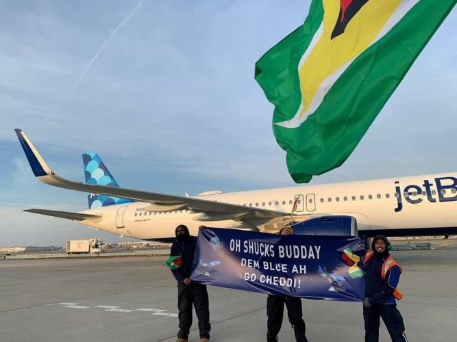 Members of the JetBlue team hold a banner in front of the aircraft used for the airline’s first nonstop flight to Guyana on Friday. (U.S. Embassy Guyana photo)