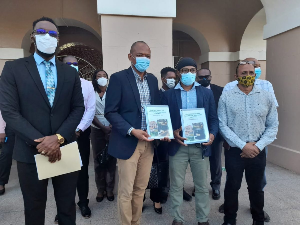 Members of the Opposition with copies of the amended bill that was presented to Parliament on Thursday. In picture from left are Chief Whip Christopher Jones, Members of Parliament Sherod Duncan and Jermaine Figueira   and AFC member Michael Carrington
