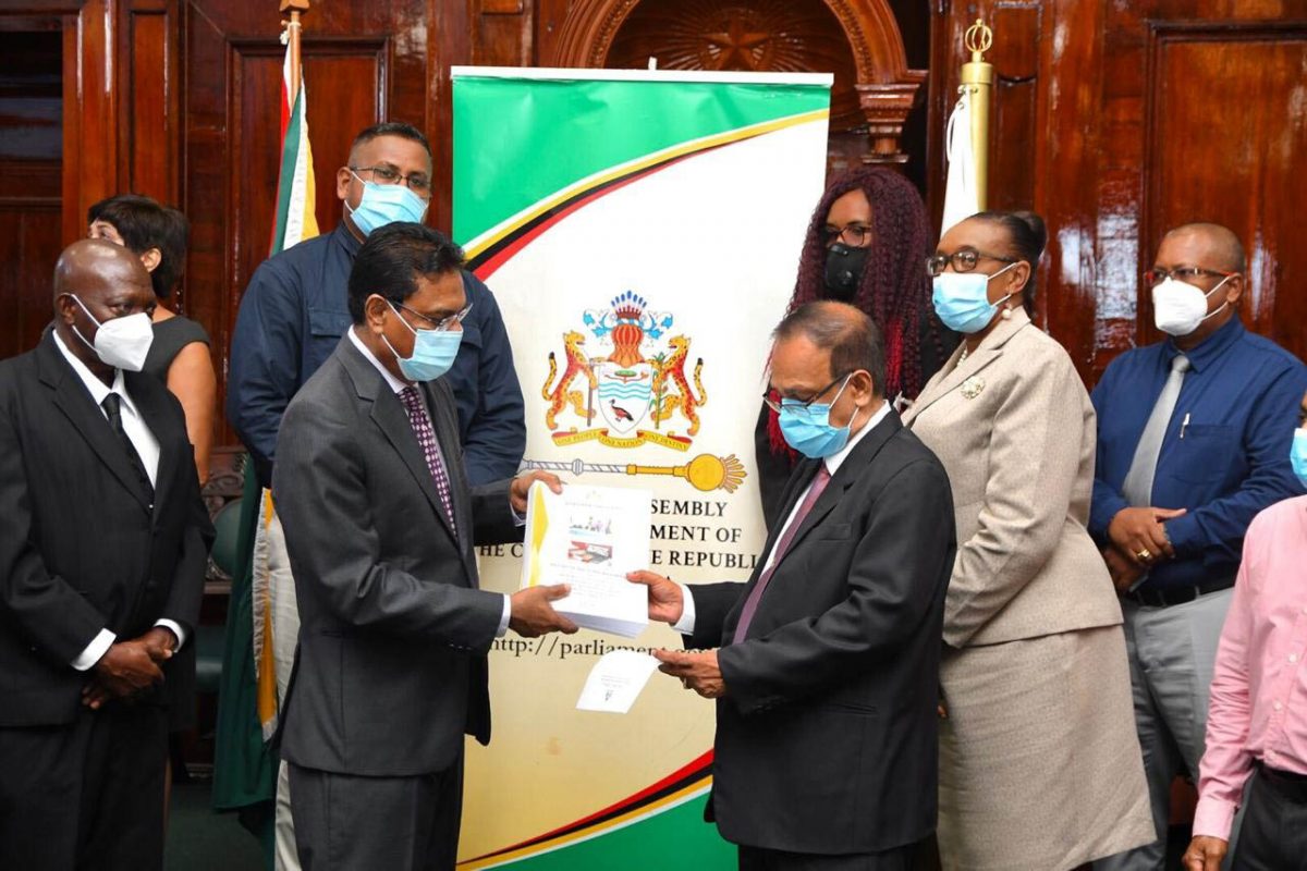 Speaker of the National Assembly Manzoor Nadir (left) accepting the Auditor General’s Report for the fiscal year ended December 31st, 2019 from Auditor General Deodat Sharma at Parliament Building yesterday. (DPI photo)

