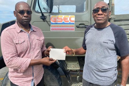 Ground Structures Engineering Consultants (GSEC) Managing Director, Charles Ceres (right) presents a sponsorship cheque to Aubrey ‘Shanghai’ Major, a director of the Kashif and Shanghai (K&S) Organization.
