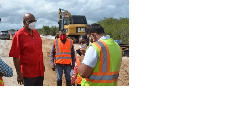 Minister of Public Works, Juan Edghill (left) speaks with the contractor responsible for roadworks leading to St. Cuthbert’s Mission. (DPI photo)