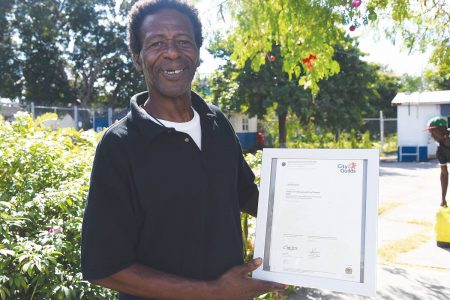 Devon Wade, a resident of the Open Arms Drop-in Centre, proudly shows off his City and Guilds skills certificate.
