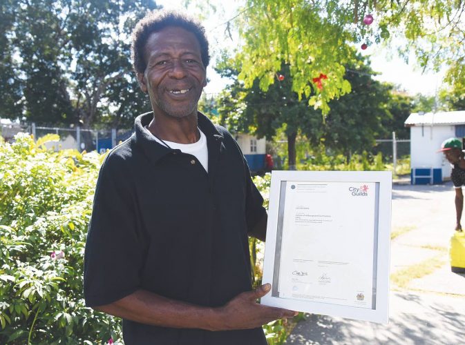 Devon Wade, a resident of the Open Arms Drop-in Centre, proudly shows off his City and Guilds skills certificate.

