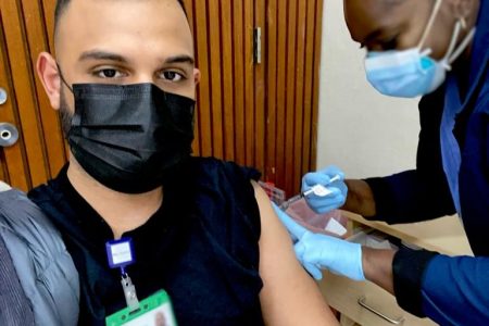 Trinidad & Tobago doctor Mateus Fernandez receives the Pfizer vaccine.
