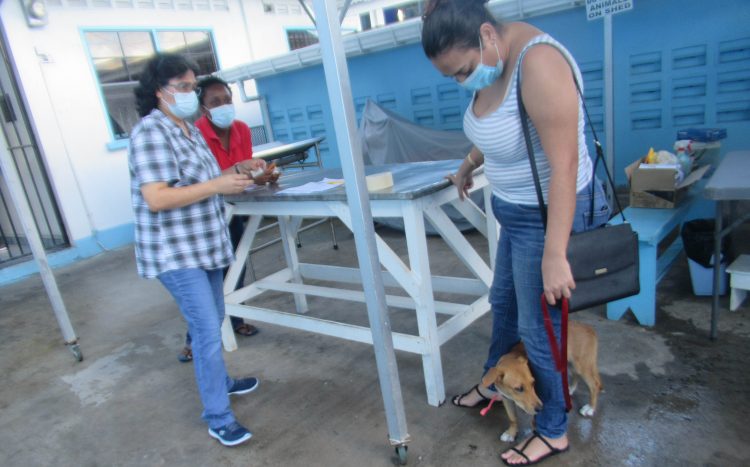 Dominique (left) registering a dog for the recently held spaying & neutering campaign