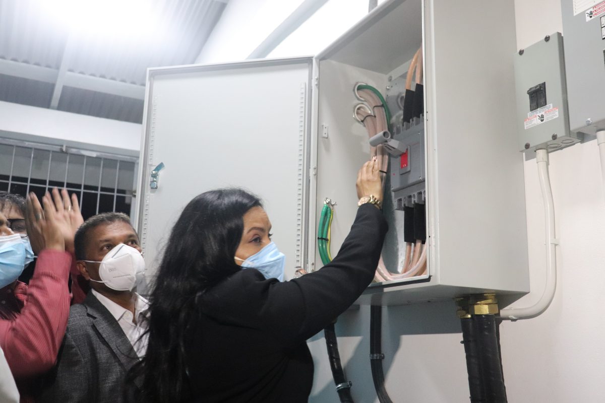Minister of Human Services and Social Security, Dr. Vindhya Persaud flicks the switch to power the lights at La Bonne Intention Ground (Romario Samaroo photo)