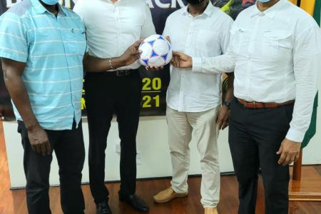 Minister of Sport, Charles Ramson Jr., (second from left) poses with the principals of the K&S Organization, Aubrey ‘Shanghai’ Major (left) and Kashif Muhammad (right) along with President of the GFF, Wayne Forde following the recent launch of the ‘Bounceback’ Tournament.