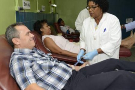 Nurse Adrick McDowe-Reid (right) prepares Dr José Armando Arronte Villamarin (left), head of Cuban medical services in Jamaica, for a blood donation in this January 2019 photo. Villamarin says Cuba’s medical missions around the world will be among the first of the country’s citizens to be inoculated when it starts its COVID-19 vaccination programme.