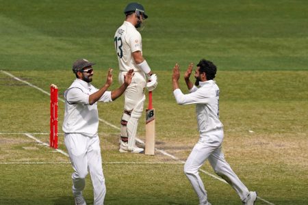  India’s Ravindra Jadeja celebrates with Ajinkya Rahane after taking the wicket of Australia’s  Matthew Wade during day three of the second test match at The MCG, Melbourne, Australia, yesterday. AAP Image/Scott Barbour via REUTERS