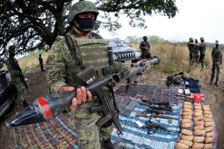 A soldier holds up a seized grenade launcher after an operation at the village of Guayabal outside Veracruz March 6, 2012. REUTERS/Yahir Ceballos/File Photo