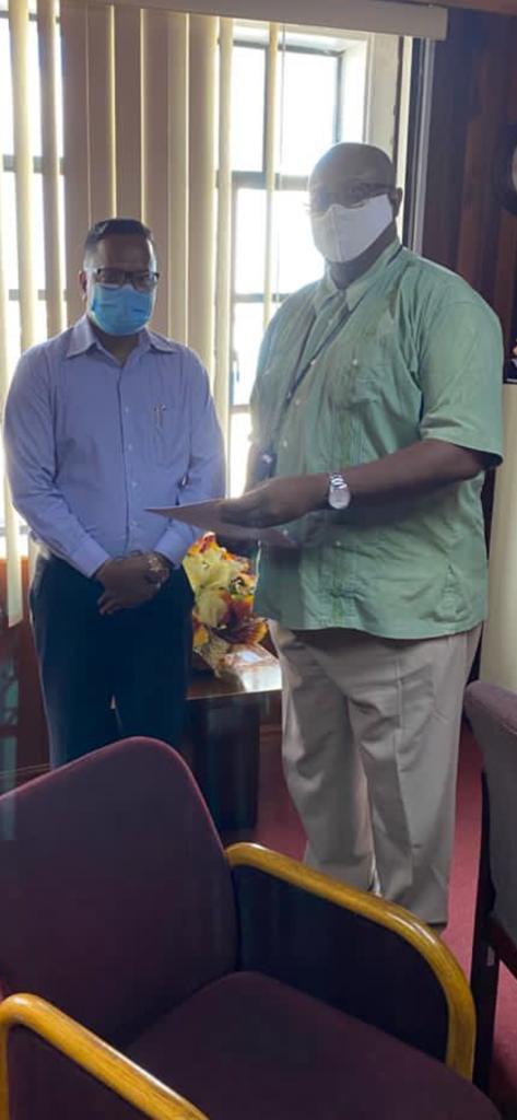 Tameshwar Jagmohan (left) receiving the quarry licence from GGMC Commissioner Newell Dennison