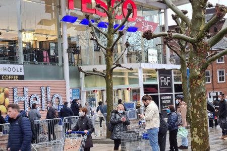 FILE PHOTO: Customers queue outside a Tesco supermarket amid the coronavirus disease (COVID-19) outbreak in London, Britain December 21, 2020 in this picture obtained from social media. Mark Hall/via REUTERS