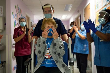 Margaret Keenan, 90, is applauded by staff as she returns to her ward after becoming the first person in Britain to receive the Pfizer/BioNTech COVID-19 vaccine at University Hospital, at the start of the largest ever immunisation programme in the British history, in Coventry, Britain Dec 8, 2020. REUTERS 