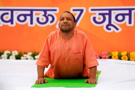 FILE PHOTO: Yogi Adityanath, Chief Minister of India's most populous state of Uttar Pradesh, performs yoga during a practice session in Lucknow, India June 7, 2017. REUTERS/Pawan Kumar