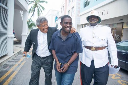 In this 2015 photo, Matthew Sewell (centre) and his lawyer Fred Smith QC (left) are heading to the Bahamian Supreme Court in Nassau. Sewell is escorted by a Bahamian policeman.
