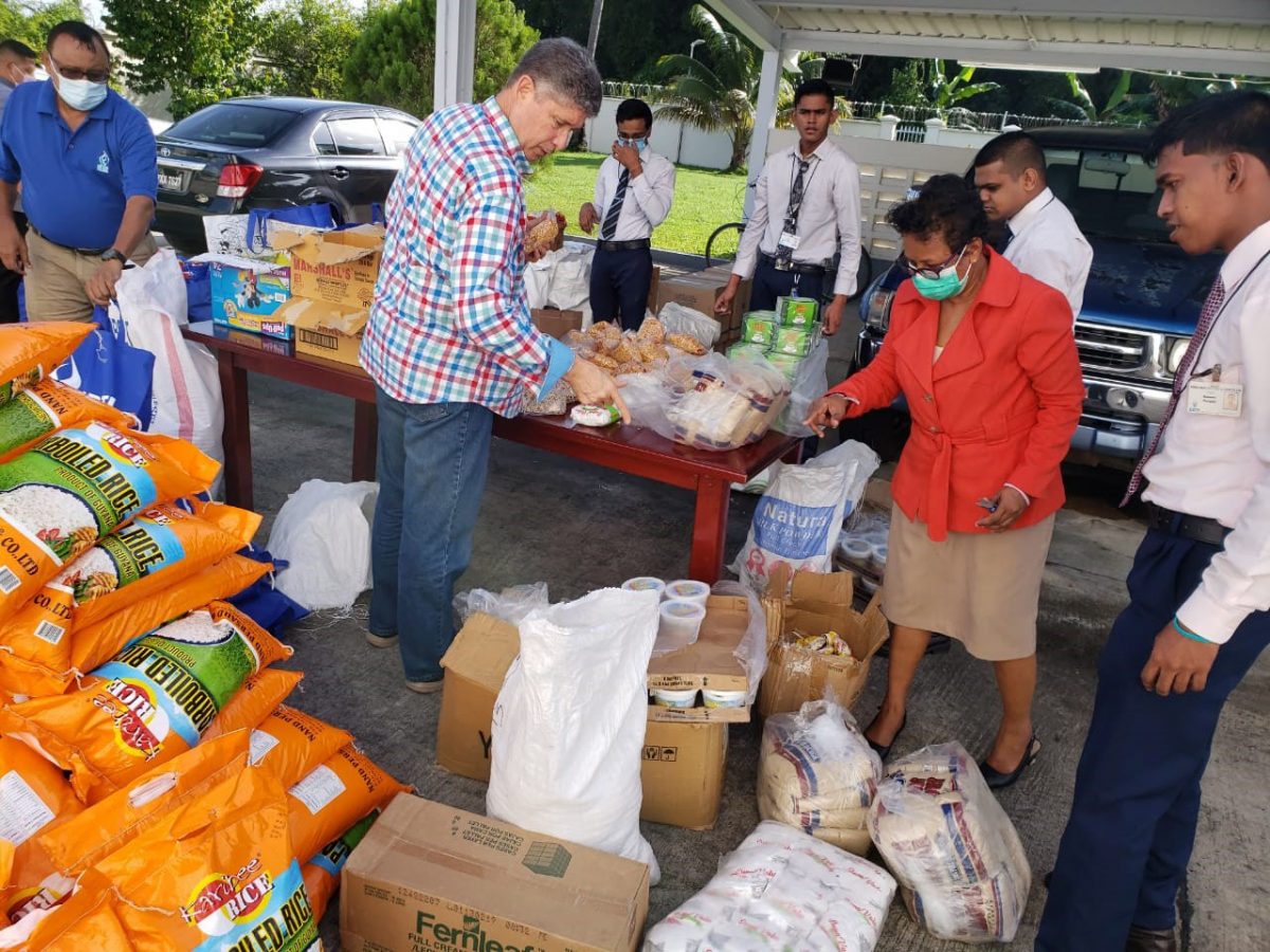 Members of the Anna Regina Team and CEO (ag) James Foster preparing hampers for residents. (GBTI photo)