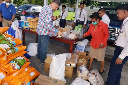 Members of the Anna Regina Team and CEO (ag) James Foster preparing hampers for residents. (GBTI photo)