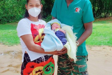 Corporal Dominique Gonsalves-Sabola (right) with Yancelis Diaz and her newborn baby. (GDF photo)