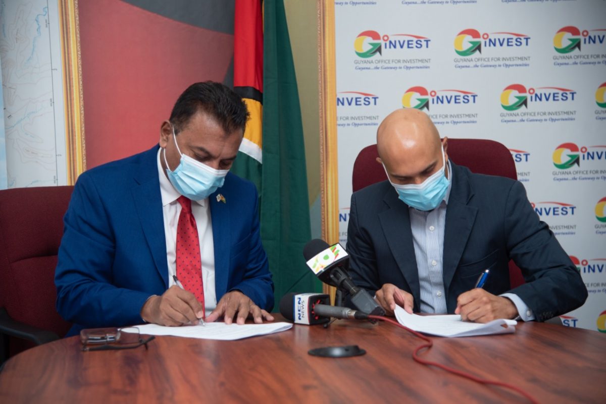 CEO of GO-Invest Dr Peter Ramsaroop (left) and Chairman of PSC Nicholas Boyer singing the MOU
