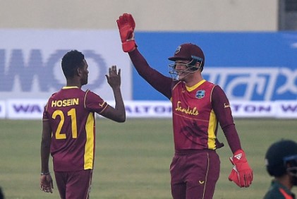Left-arm spinner Akeal Hosein is congratulated by wicketkeeper Joshua DaSilva after taking one of his wickets.