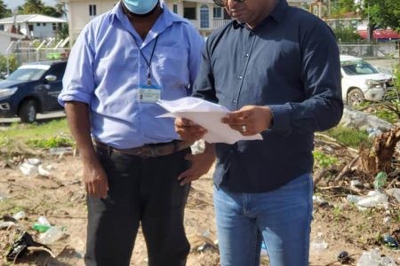 Minister in the Ministry of Public Works Deodat Indar (right) at the site yesterday.