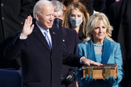 Joe Biden being sworn in as the 46th President of the United States yesterday as his wife Jill Biden holds a Bible on the West Front of the U.S. Capitol. REUTERS/Kevin Lamarque