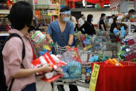 People line up to pay at a supermarket, amid the coronavirus disease (COVID-19) outbreak in Kuala Lumpur, Malaysia January 12, 2021. REUTERS/Lim Huey Teng