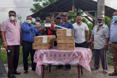 Regional officials with residents after the lights were handed over
