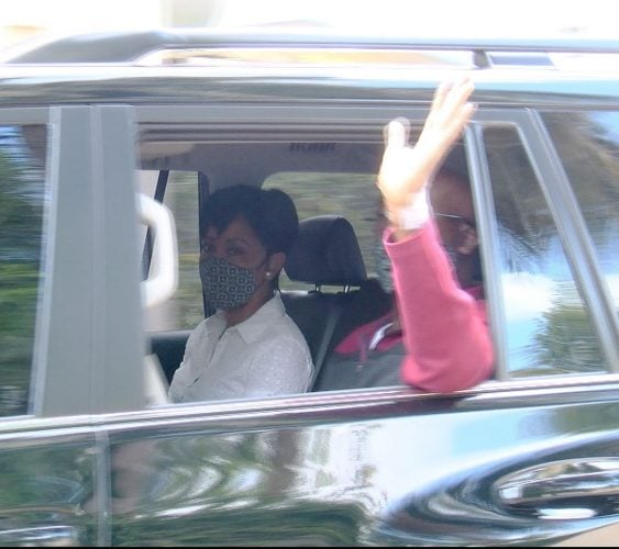 Prime Minister Dr Keith Rowley waves to members of the media as he leaves the West Shore Private Medical Hospital, Cocorite, with his wife Sharon, yesterday.