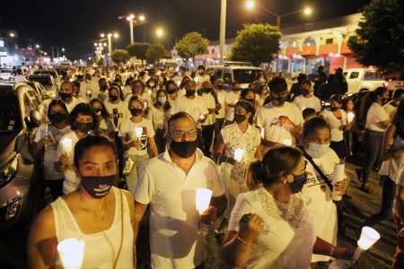 Scores of people walk along the Criosse in San Juan during a candlelight vigil for Andrea Bharatt and other female victims of violence last night.