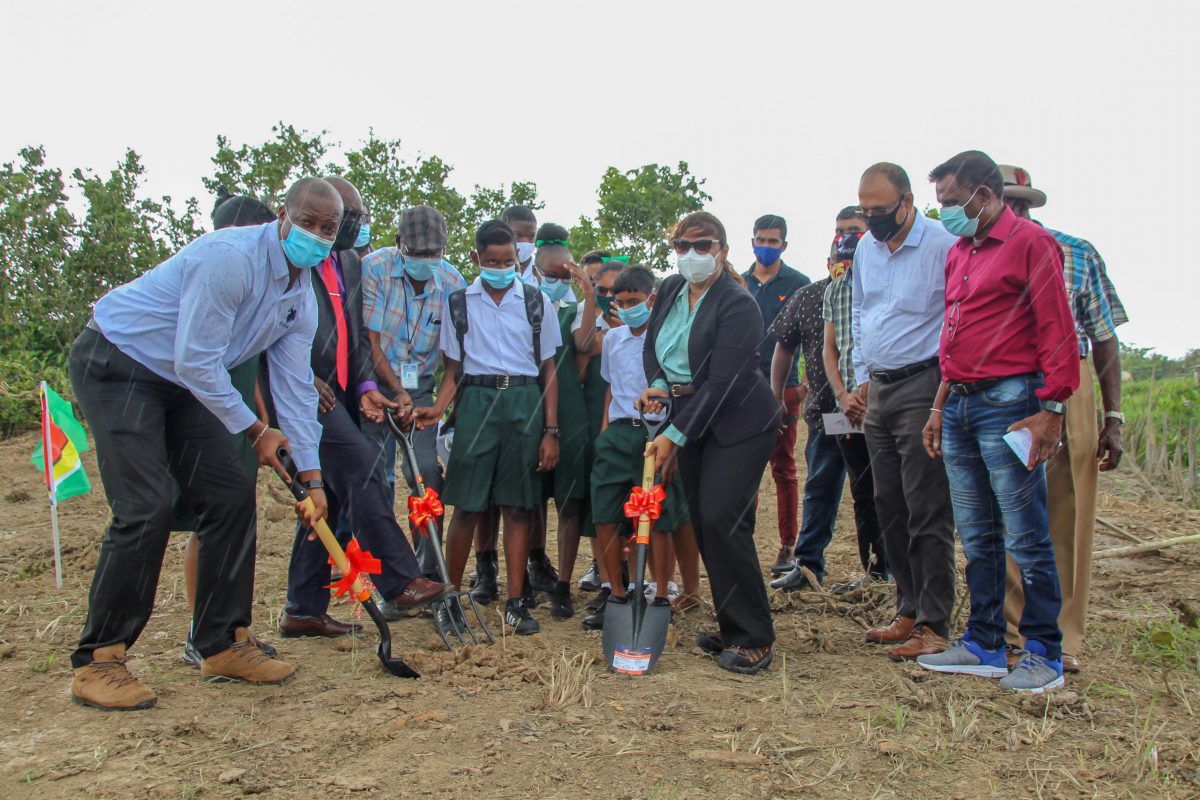 The Minister of Education, Priya Manickchand (at centre, holding a shovel), as the sod is turned for the new Prospect Secondary (See story on page 11) 