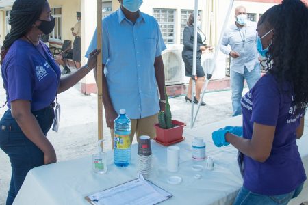 A staff member of the Ministry of Home Affairs, on Friday, taking his filaria pills as part of the Ministry of Health’s filaria immunisation campaign (DPI photo)