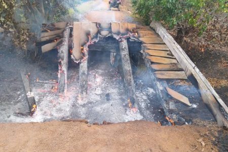 An access bridge at Yupukari, in Region Nine was yesterday morning destroyed by fire, suspected to have been deliberately set. Regional Commander Keithon King told this newspaper that a report was lodged at the Lethem Police Station and a team of police officers was dispatched to the area to investigate. Travel from Yupukari and three other communities in the North Rupununi to Lethem will be affected as a result of the bridge’s destruction as it connects the communities to the Lethem main road. (Photo taken from Minister Nigel Dharamlall’s Facebook page)