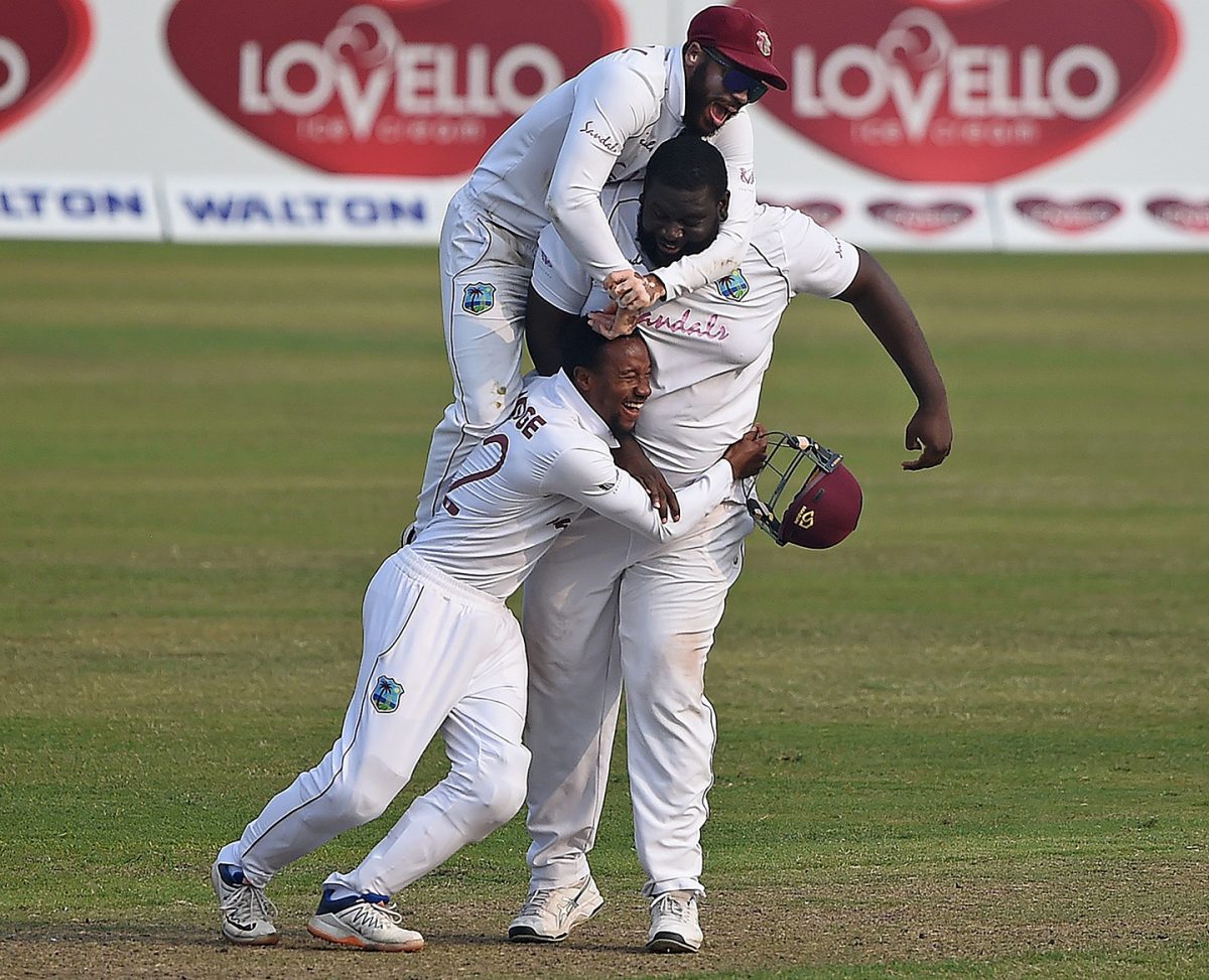 HE AIN’T HEAVY HE’S MY TEAMMATE! John Campbell (top) and substitute Kavem Hodge embrace Rahkeem Cornwall after the off-spinner took the final catch to earn West Indies victory in the second Test. 