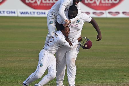 HE AIN’T HEAVY HE’S MY TEAMMATE! John Campbell (top) and substitute Kavem Hodge embrace Rahkeem Cornwall after the off-spinner took the final catch to earn West Indies victory in the second Test. 