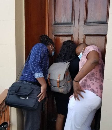 Members of the media attempting to hear the debate in the Public Accounts Committee yesterday. Those present to report on the exmination of the public accounts were asked to leave the Chamber to allow for ‘houskeeping matters’. They remained barred for the nearly two hours the motion was debated. (Photo by Thandeka Percival) 