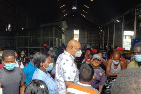 Minister Juan Edghill (centre) greeting passengers as they prepared to board the vessel yesterday afternoon
