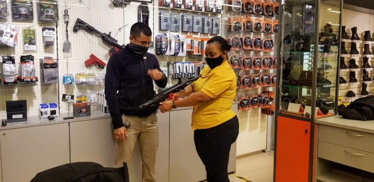 Defense Tactics Instructor and Range Safety Officer at AA Tactical, Joshua Lee demonstrates the use of a firearm to Melissa Reid.