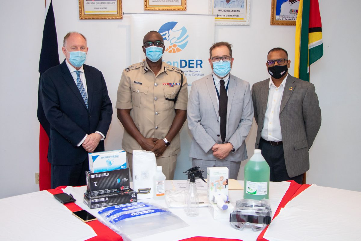 Commissioner of Police (ag), Nigel Hoppie (second from left), received items which were handed over by Canadian High Commissioner to Guyana, Mark Berman (second from right), acting UK High Commissioner to Guyana, Ross Denny (left); and UNDP Operations Coordinator, Navindra Persaud. (Department of Public Information photo)