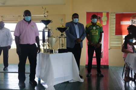 President Dr. Irfaan Ali (center) poses with the trophy alongside President of the Georgetown Softball Cricket League, Ian John (right) and Regal’s Mahendra Hardyal.