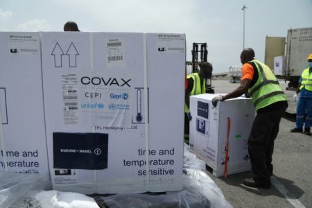 Workers offload boxes of AstraZeneca/Oxford vaccines as the country receives its first batch of coronavirus disease (COVID-19) vaccines under COVAX scheme, in Abidjan, Ivory Coast February 26, 2021. REUTERS/Luc Gnago