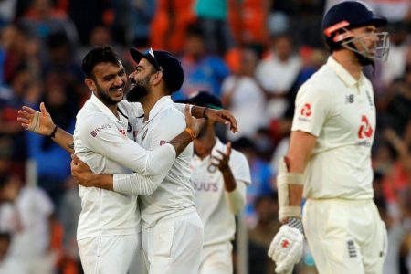 The Indian players celebrate the fall of another England batsman’s wicket.