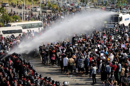 Police fire a water cannon at protesters demonstrating against the coup and demanding the release of elected leader Aung San Suu Kyi, in Naypyitaw, Myanmar, February 8, 2021. REUTERS/Stringer